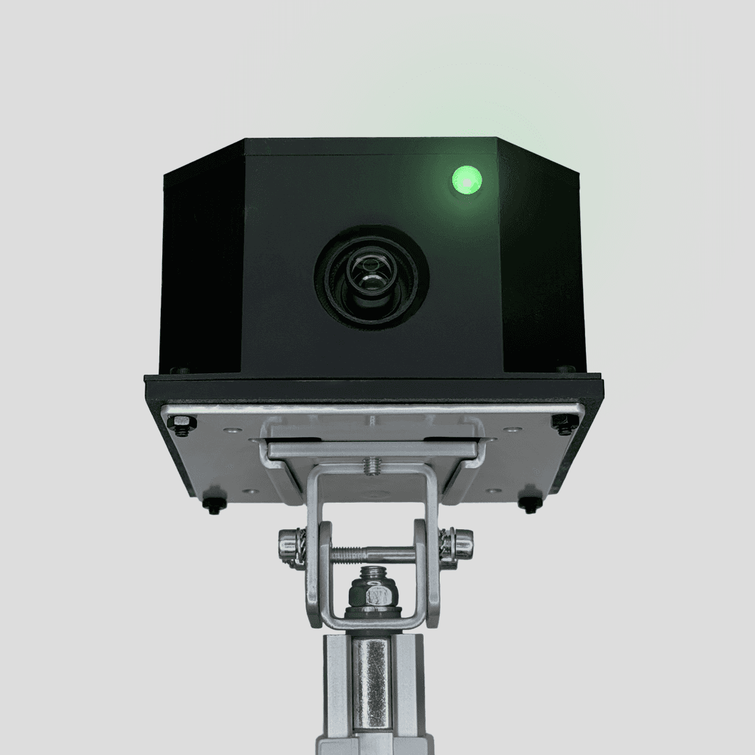 Black ClipPack camera with a green indicator light, shown on its mounting bracket